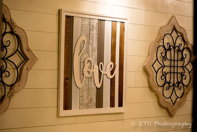 Wall art with the word 'love' in rustic frame
